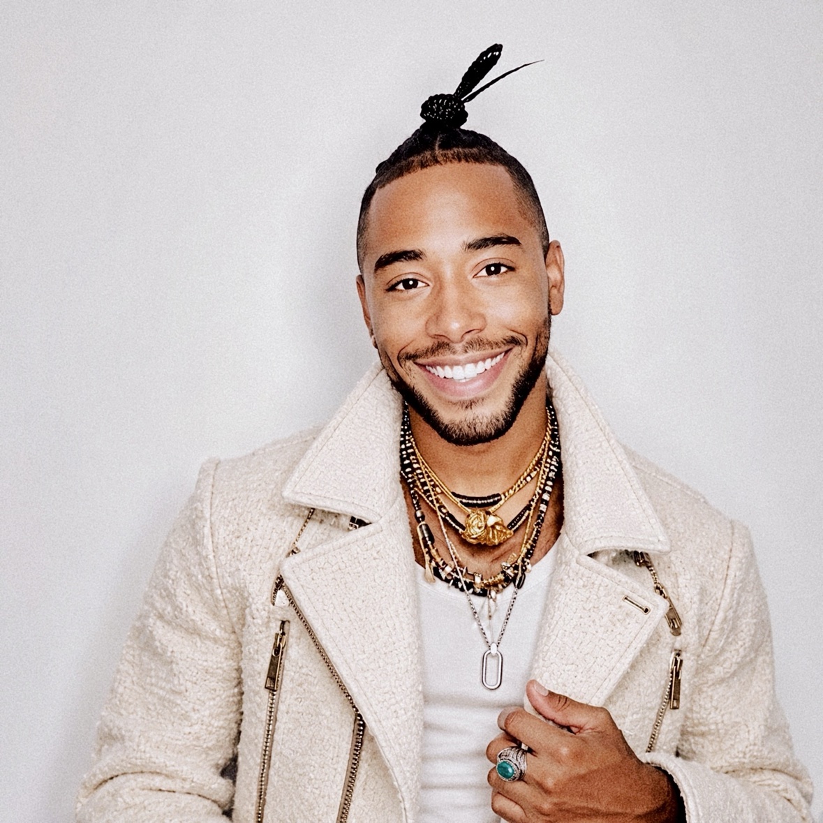 Arik Divine — cream-jacket smile portrait