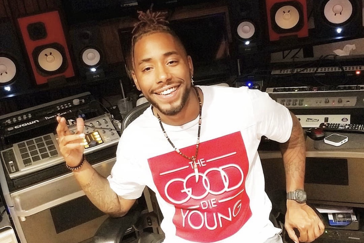 Arik Divine — in the studio, smiling at the MPC